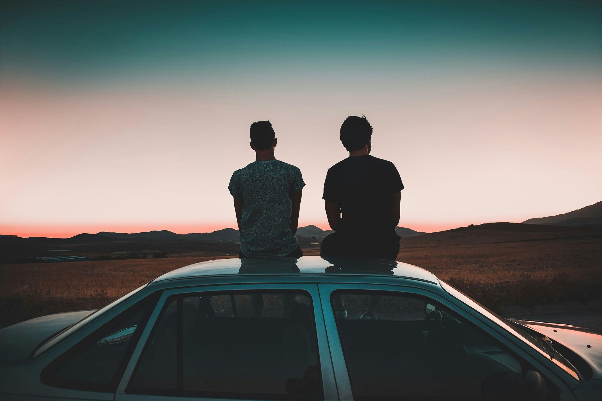 Two people staring out in parallel at the horizon