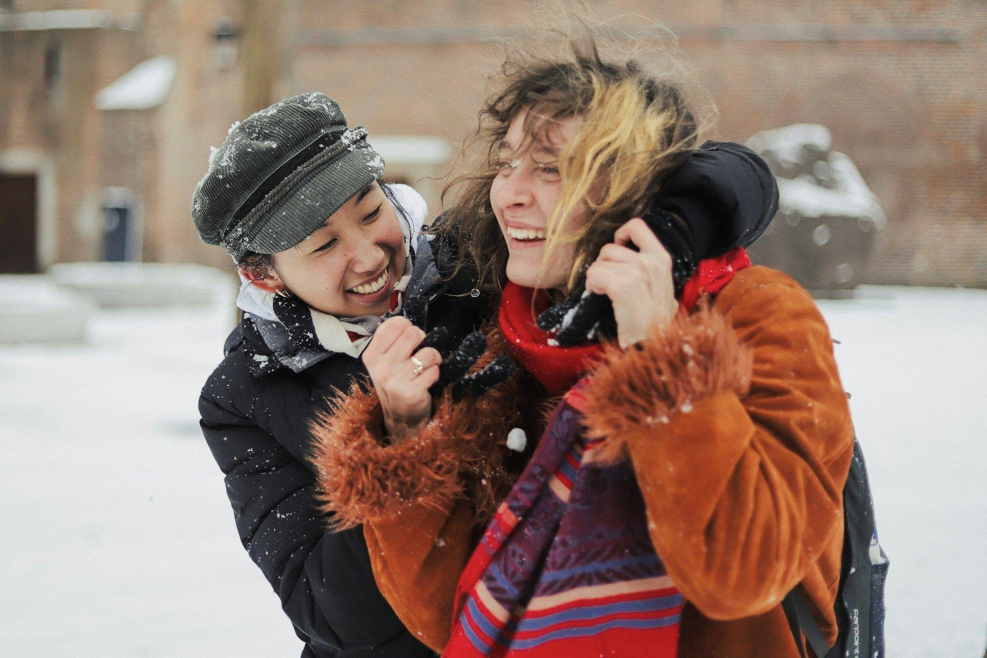 Two people playing in the snow